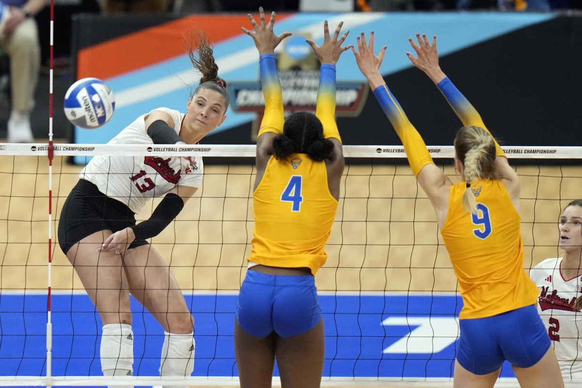 Nebraskas Merritt Beason (13) scores past Pittsburghs Torrey Stafford (4) and Emma Monks (9) during a semifinal match in the NCAA Division I womens college volleyball tournament Thursday, Dec. 14, 2023, in Tampa, Fl.