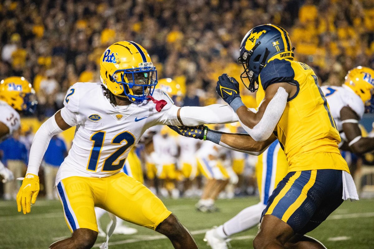 Redshirt senior defensive back M.J. Devonshire (12) guards a West Virginia player during the Backyard Brawl in Morgantown, West Virginia, on Saturday, Sept. 16.