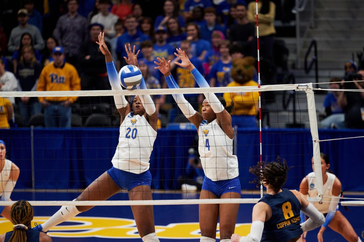 First-year outside hitter Torrey Stafford (4) and graduate student middle blocker Chiamaka Nwokolo (20) jump to block a ball during Friday night’s volleyball match against Coppin State in the first round of the 2023 NCAA Tournament at the Petersen Events Center. 