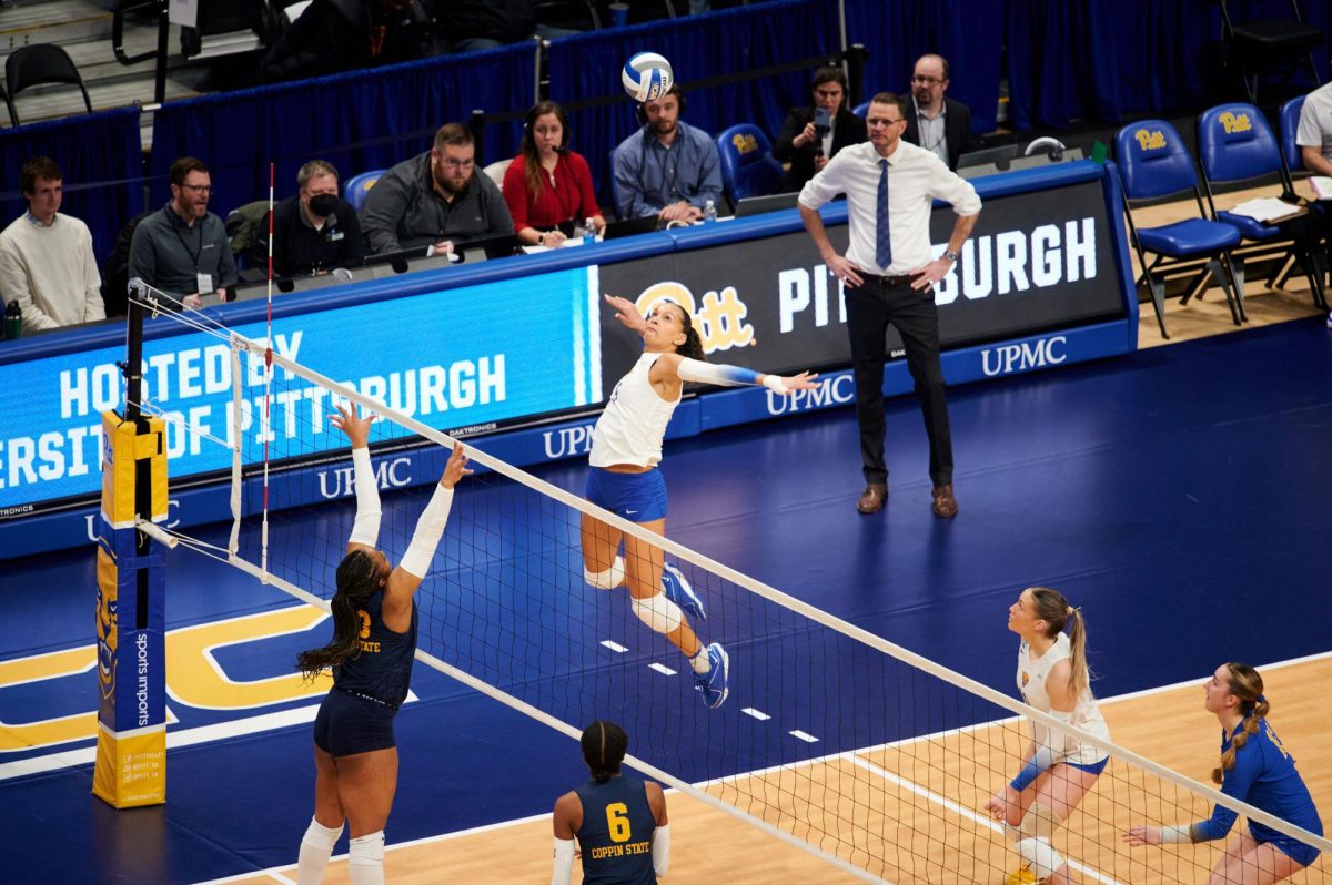 First-year rightside hitter Olivia Babcock (5) spikes the ball during Friday night’s volleyball match against Coppin State in the first round of the 2023 NCAA Tournament at the Petersen Events Center. 
