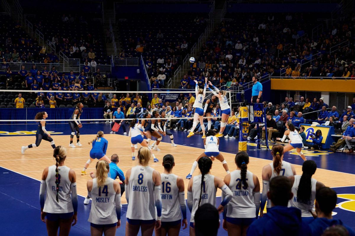Graduate student Emma Monks (9) and junior Rachel Fairbanks (10) jump to block a ball during Friday night’s volleyball match against Coppin State in the first round of the 2023 NCAA Tournament at the Petersen Events Center. 