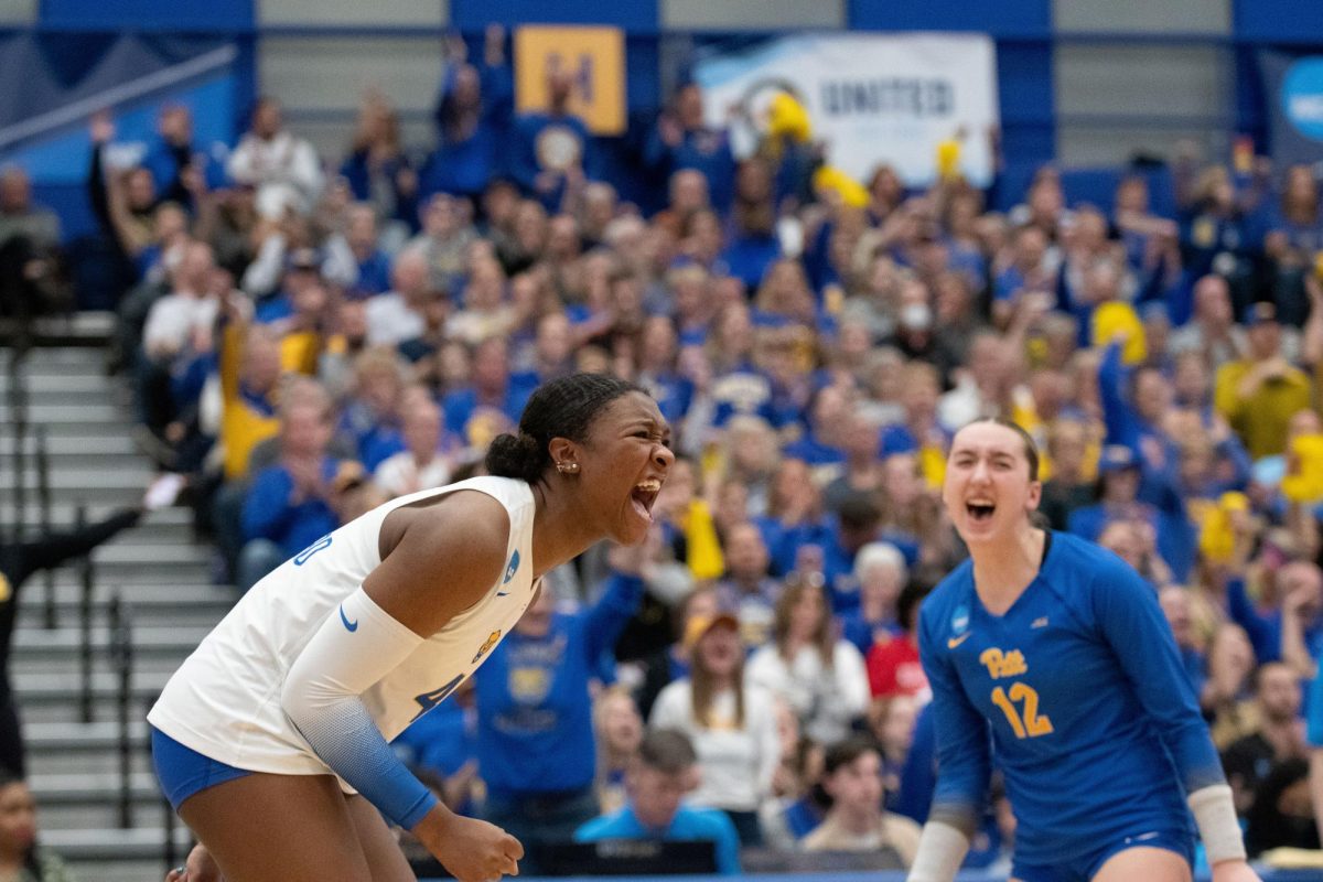 First-year outside hitter Torrey Stafford (4) screams following a point during the Elite Eight matchup against Louisville on Saturday afternoon in the Fitzgerald Field House.