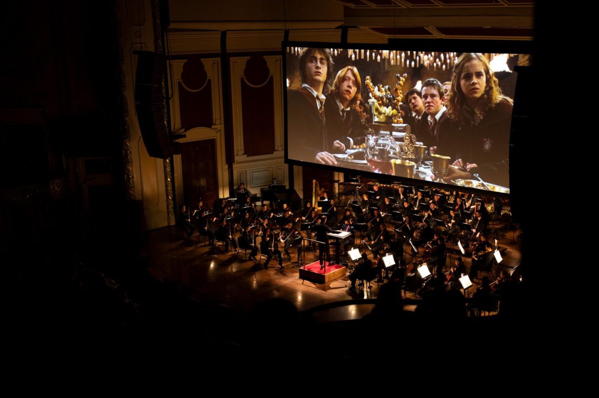 The Pittsburgh Symphony Orchestra plays along with “Harry Potter and the Goblet of Fire” playing on the screen above them. 