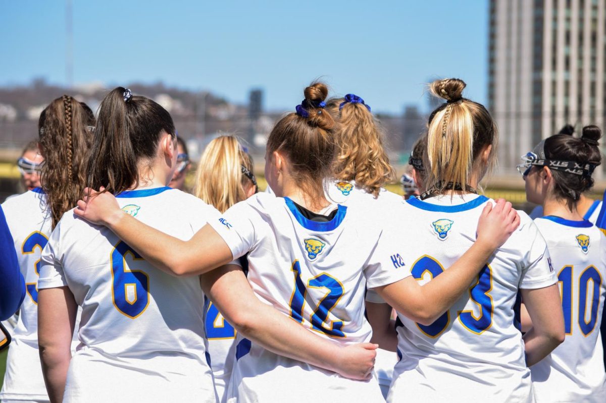 Pitt women’s lacrosse players huddle up during a game against Duke at Highmark Stadium on Sunday, March 26, 2023.