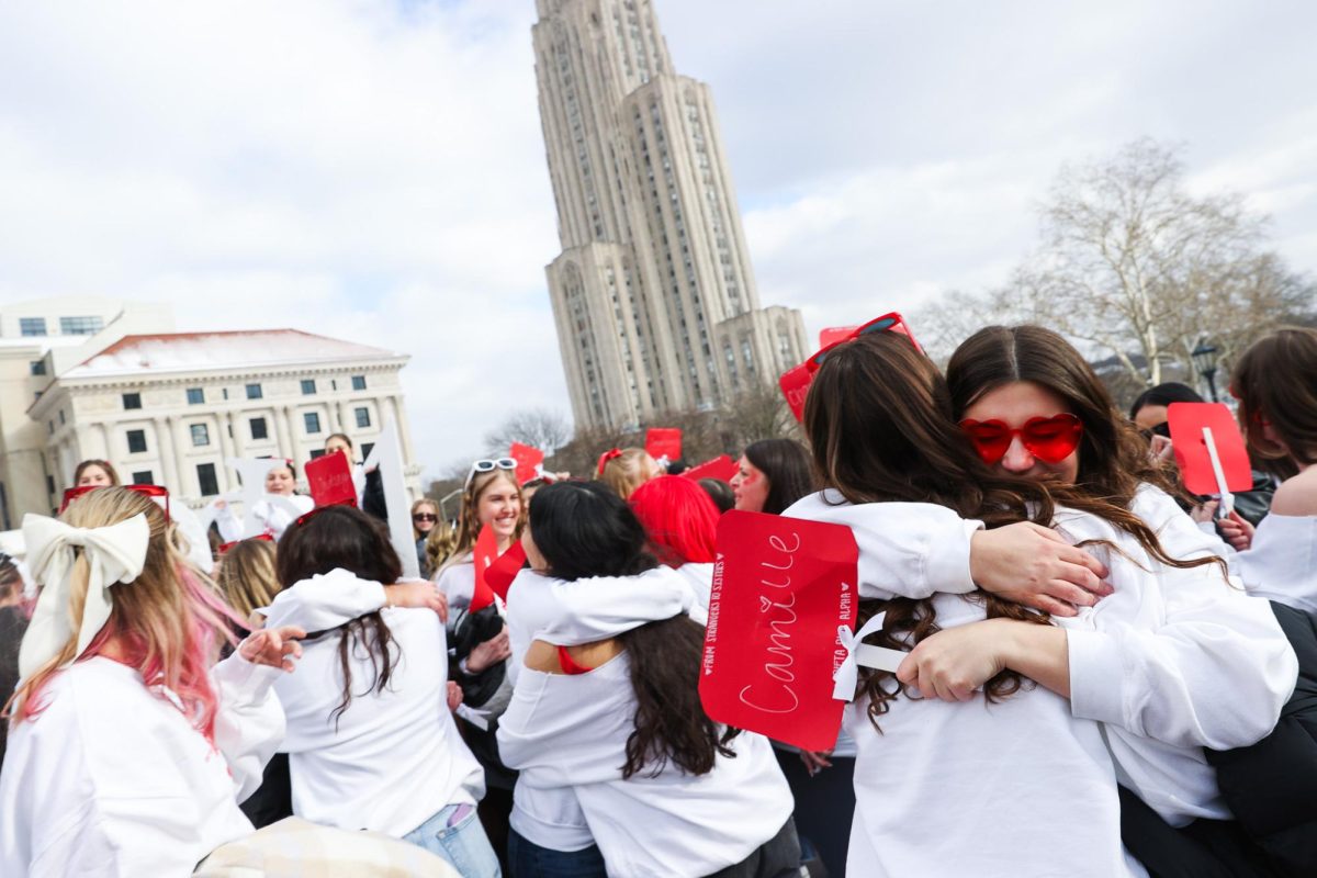 Members of Theta Phi Alpha embrace during Sunday afternoon’s Bid Day on Soldiers and Sailors Lawn.