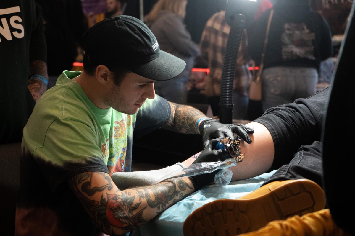 An artist works on a tattoo for a customer at the Pittsburgh Tattoo Expo on Saturday at the David L. Lawrence Convention Center.