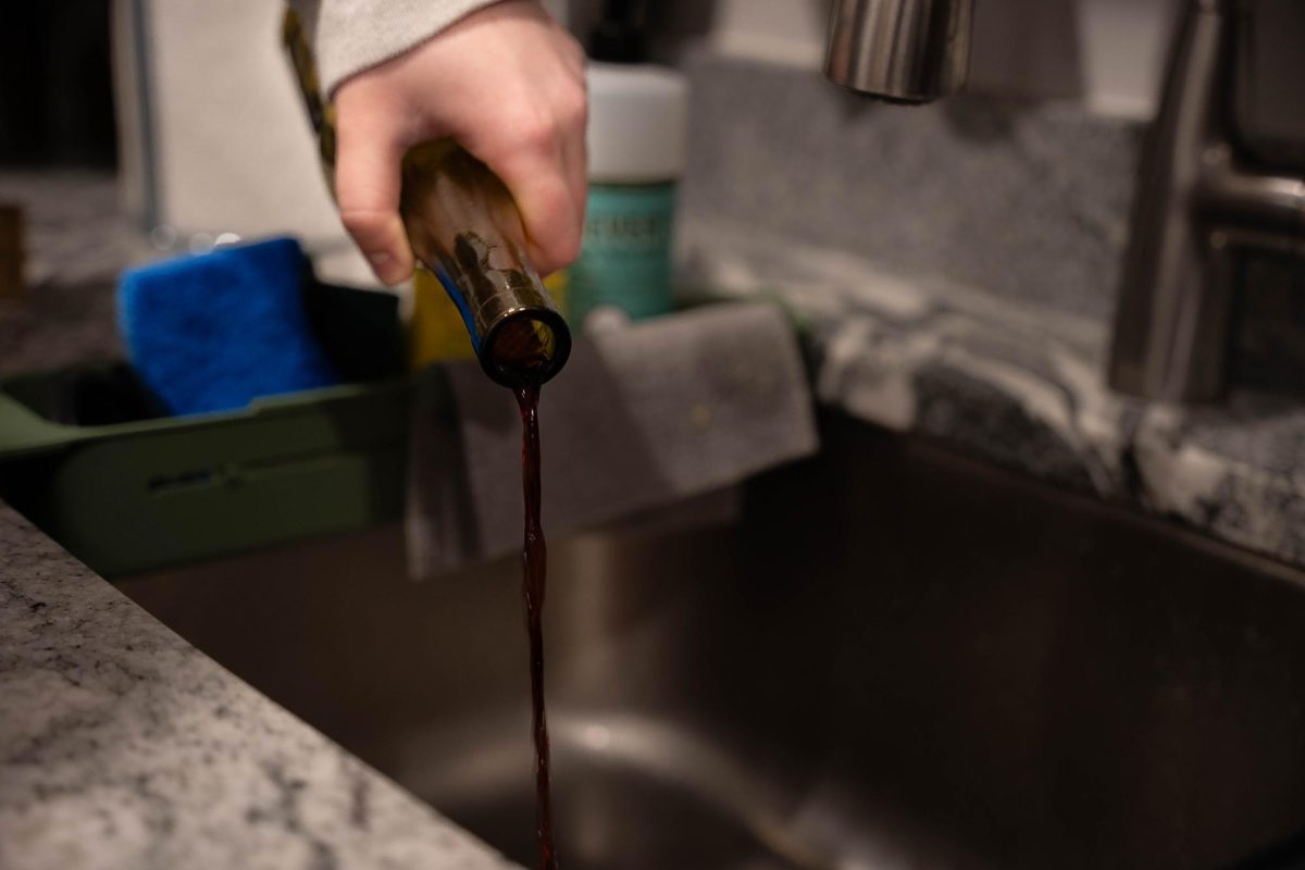 Wine is poured into a sink.