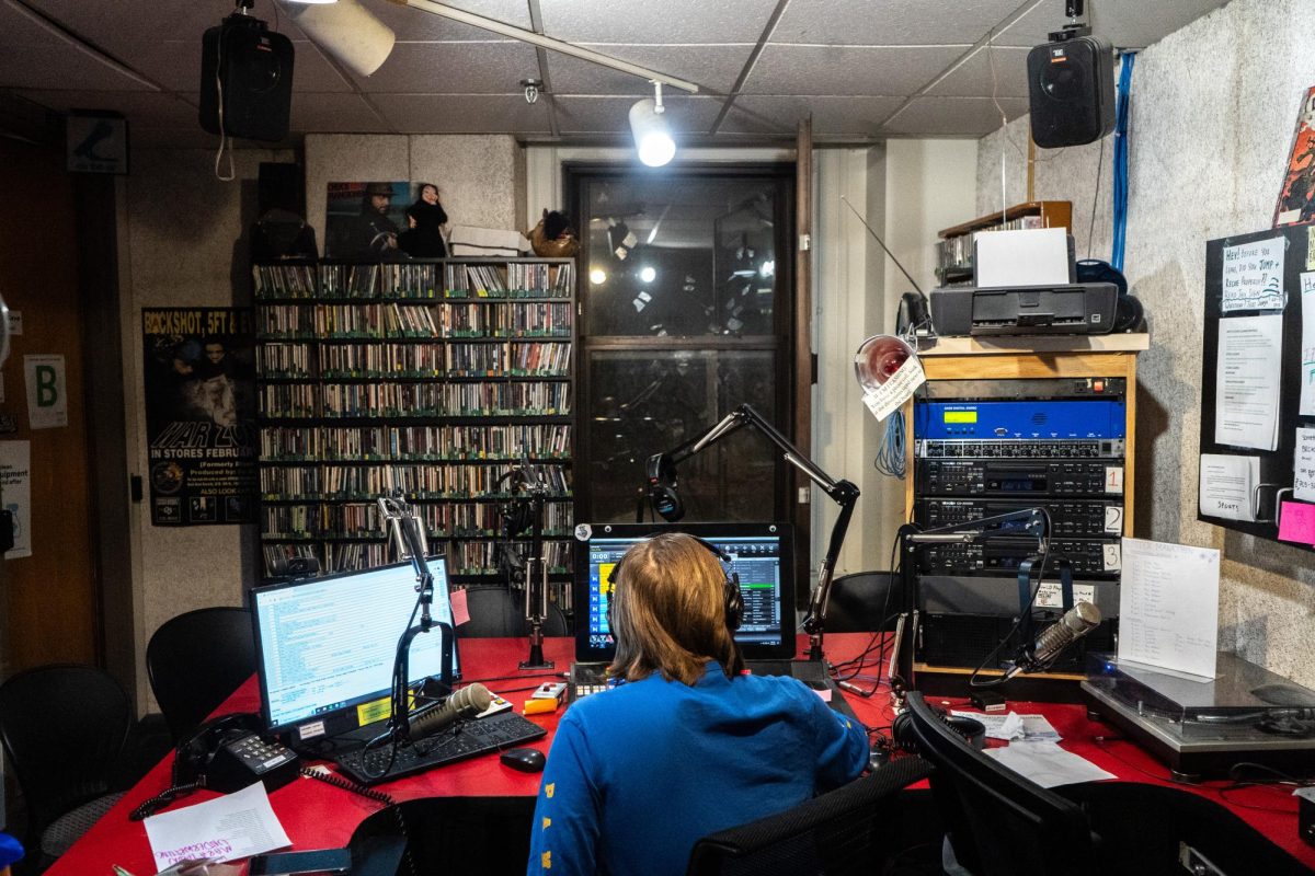 A WPTS broadcaster manages the soundboard during the Winter Marathon at the WPTS studio in the William Pitt Union.