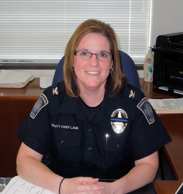 Chief of Police Holly A. Lamb poses for a photo at her desk.