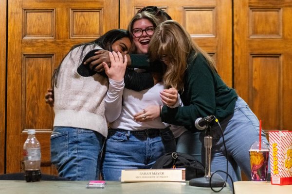 Members of The Blank Slate, led by President-elect Sarah Mayer (center), celebrate the election results during Student Government Board’s public meeting on Tuesday in Nordy’s Place.