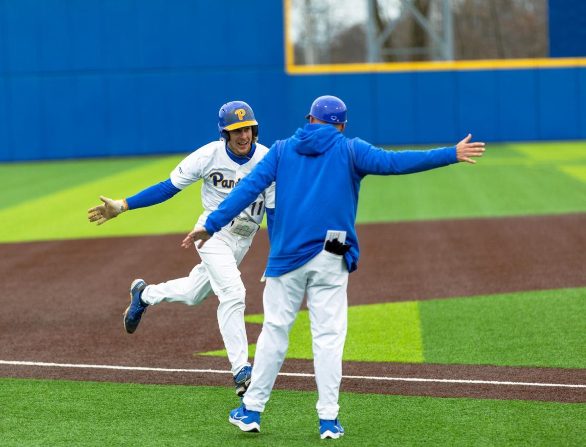 Pitt junior infielder Brock Franks (11) high fives another player during their game against Clemson on March 25, 2022.
