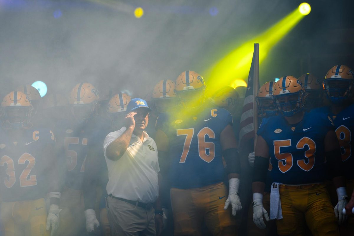 Pitts football team and head coach Pat Narduzzi walk out for the first game of the season against Wofford at Acrisure Stadium on Sept. 2, 2023. 