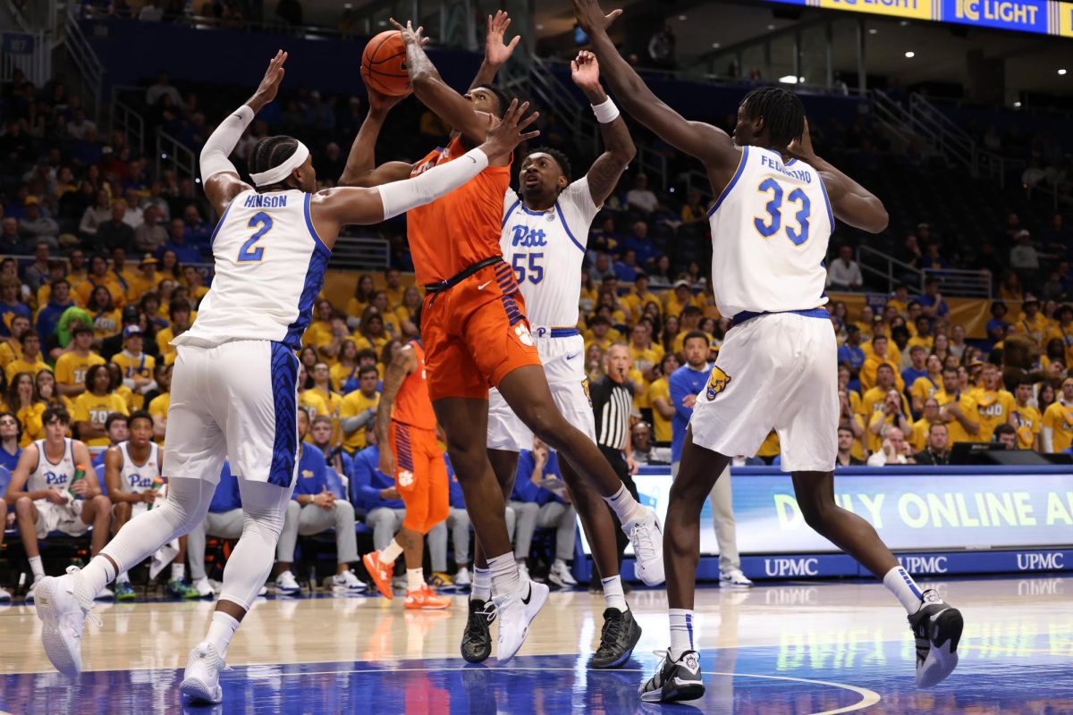 Pitt players converge to defend the basket as a Clemson player attempts a layup during a game at the Petersen Events Center on Dec. 3, 2023. 