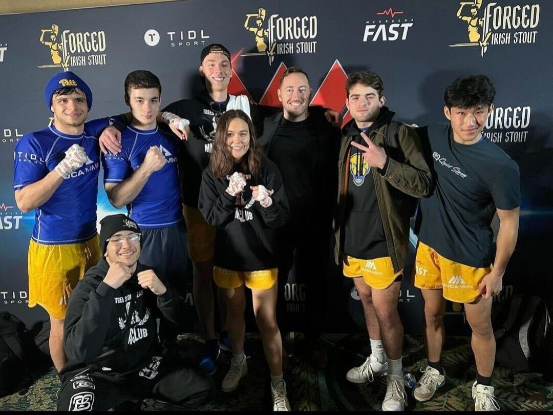 Members of Pitt’s MMA club pose for a photo at a competition.