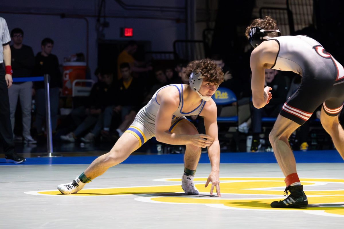 A Pitt wrestler competes during Thursday evening’s meet against Rider in the Fitzgerald Field House.