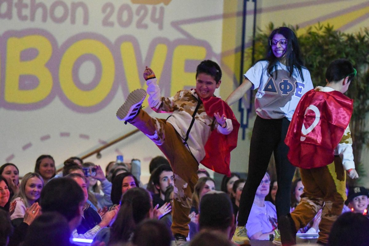 A miracle kid kicks on stage during the fashion show in the William Pitt Union Assembly Room on Wednesday evening.