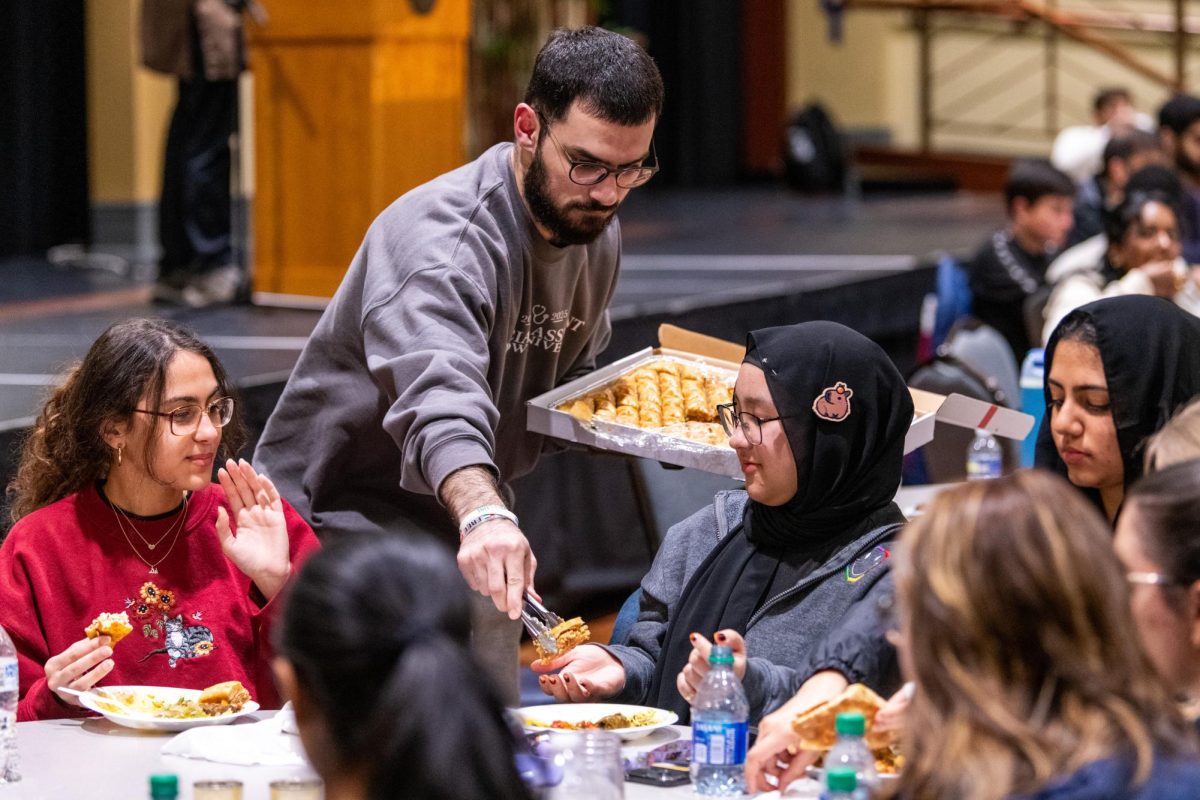 Community+member+Abdualrahman+passes+out+baklava+to+the+Muslim+Student+Association%E2%80%99s+Fast-a-Thon+attendees+in+the+William+Pitt+Union+on+Wednesday+night.