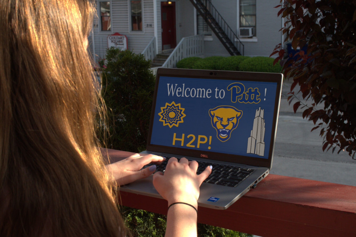 A+student+looks+at+a+laptop+screen+that+reads+%E2%80%9CWelcome+to+Pitt.%E2%80%9D