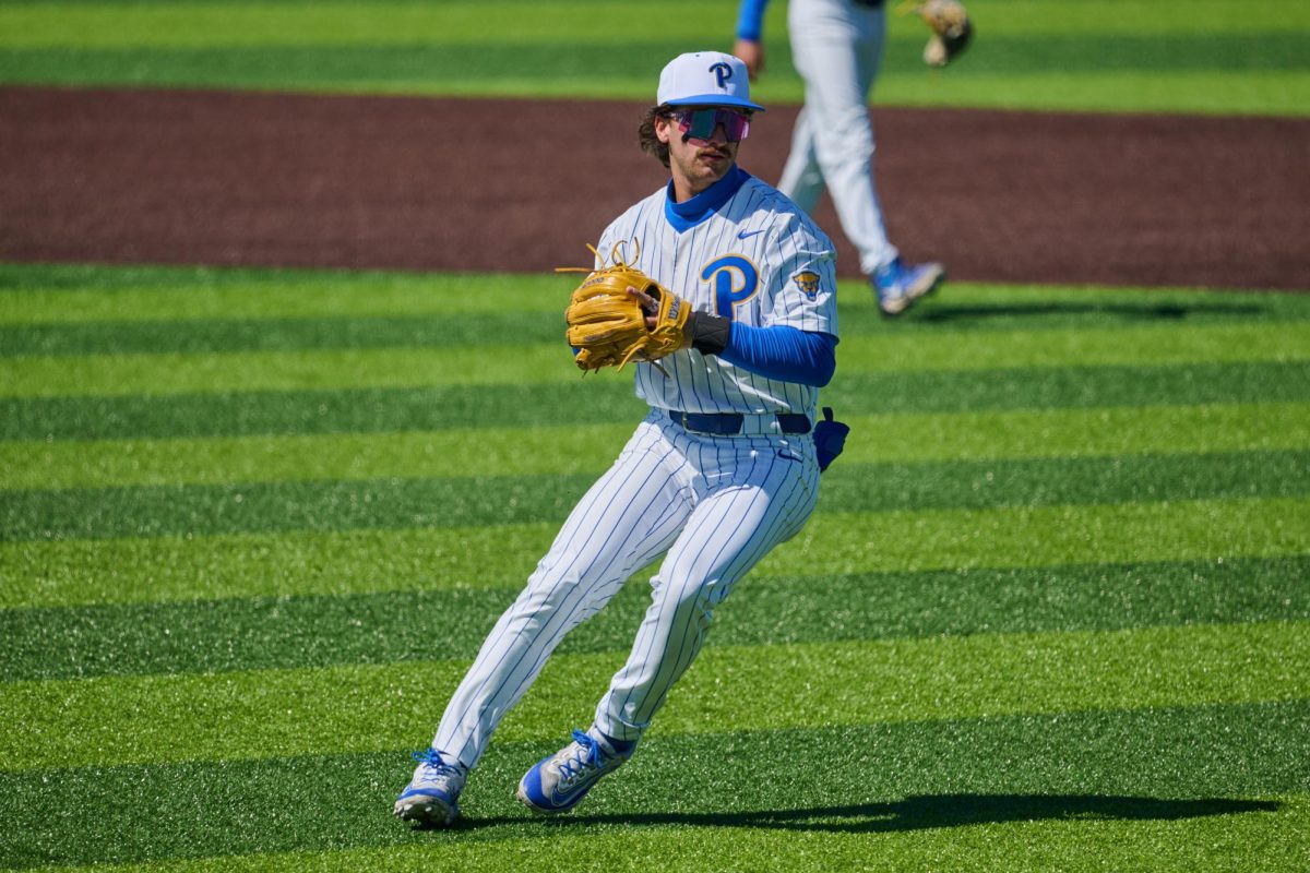 Senior infielder Tyler Bischke (1) winds up for a throw during Sunday’s game against UVA at Cost Field.