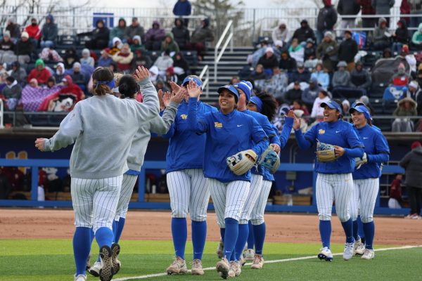 Pitt softball players high-five during their match against Florida State at Vartabedian Field on March 23.
