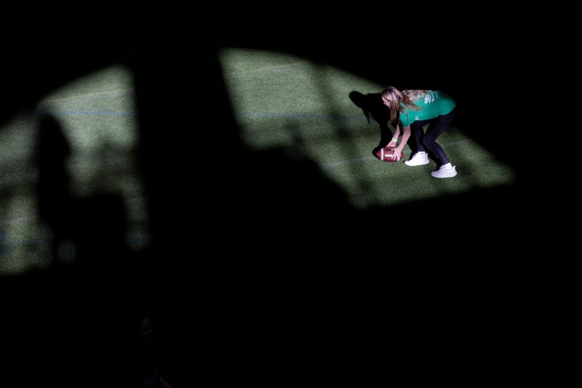 An event participant plays football during Pitt Dance Marathon’s event on Saturday at the Charles L. Cost Sports Center.