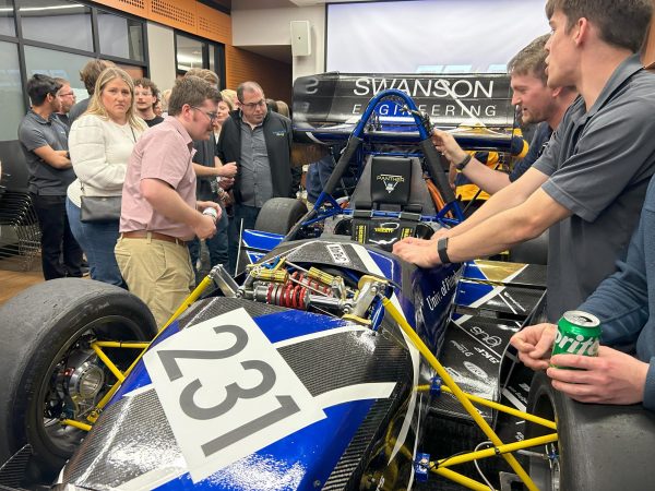 Students and community members gather to see Panther Racing unveil its car in Benedum Hall on Saturday evening. 