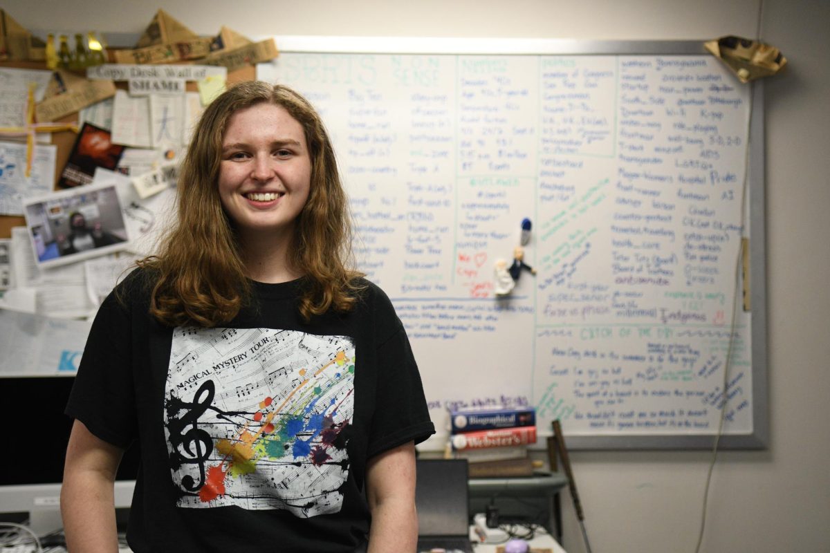 Allison Schaeffer, graduating senior and copy chief of The Pitt News, poses for a photo in front of the copy board at The Pitt News office on Tuesday.