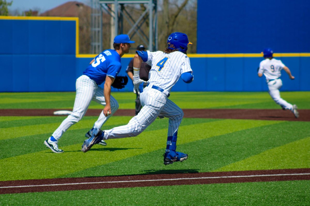 Sophomore shortstop Jake Kendro (4) attempts to outrun the throw during the baseball game against Duke on Sunday afternoon at Charles L. Cost Field.