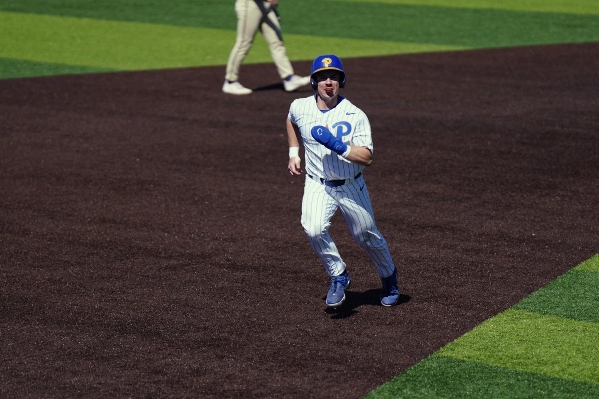 A Pitt player runs to third base during Sunday’s game against Georgia Tech at the Charles L. Cost Field.