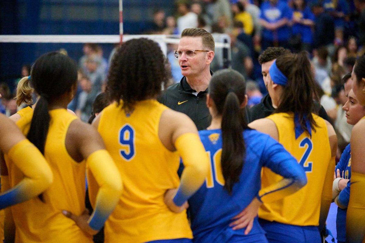 Head coach Dan Fisher speaks to the team after the women’s volleyball game against Penn State on Sunday afternoon in the Fitzgerald Field House.