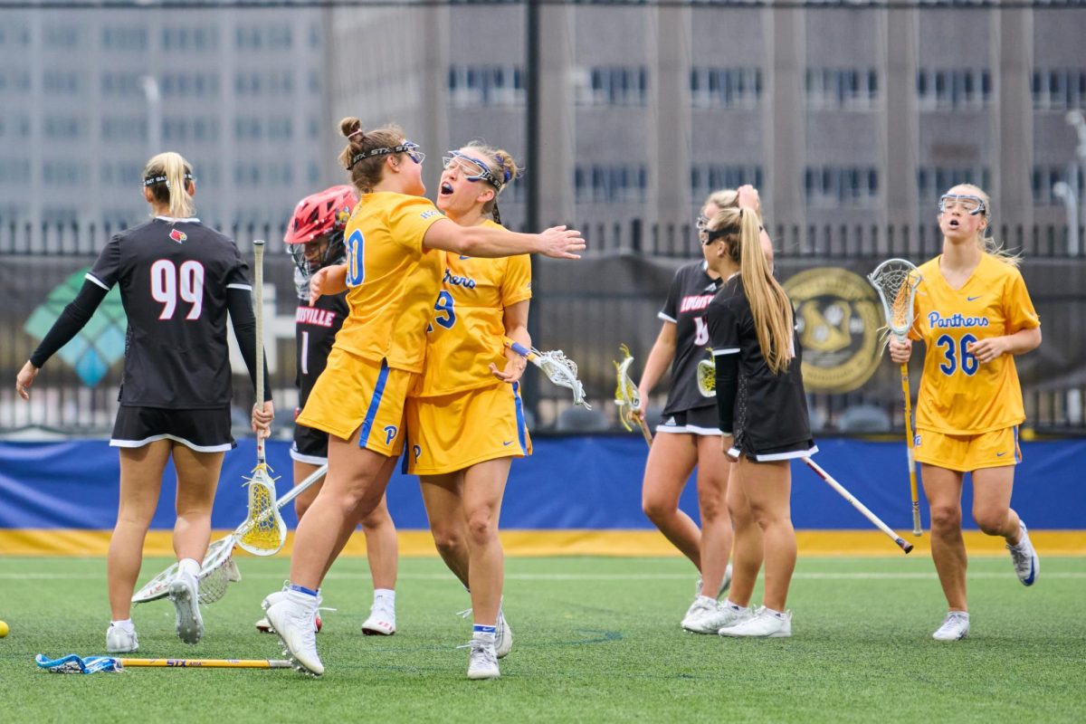 Fifth-year attacker Camdyn ODonnell (20) and junior midfielder Talia Zuco (19) celebrate during a lacrosse game against Louisville at Highmark Stadium on March 2.