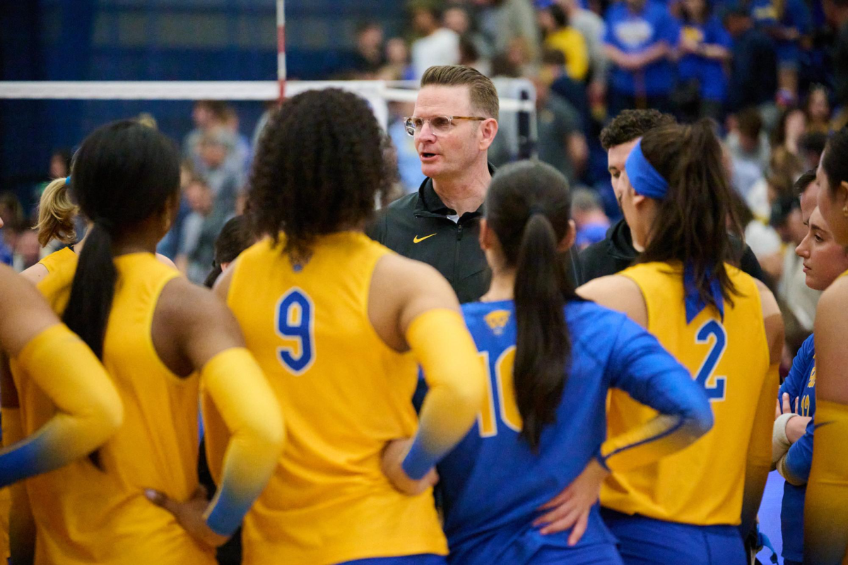 Head coach Dan Fisher speaks to the Pitt volleyball team after their match Fitzgerald Field House.
