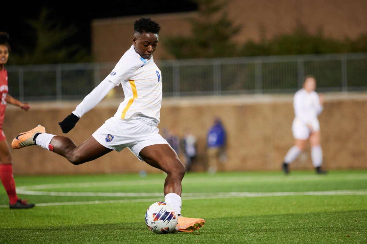 Sophomore midfielder Deborah Abiodun (8) strikes the ball during a game against Ohio State.
