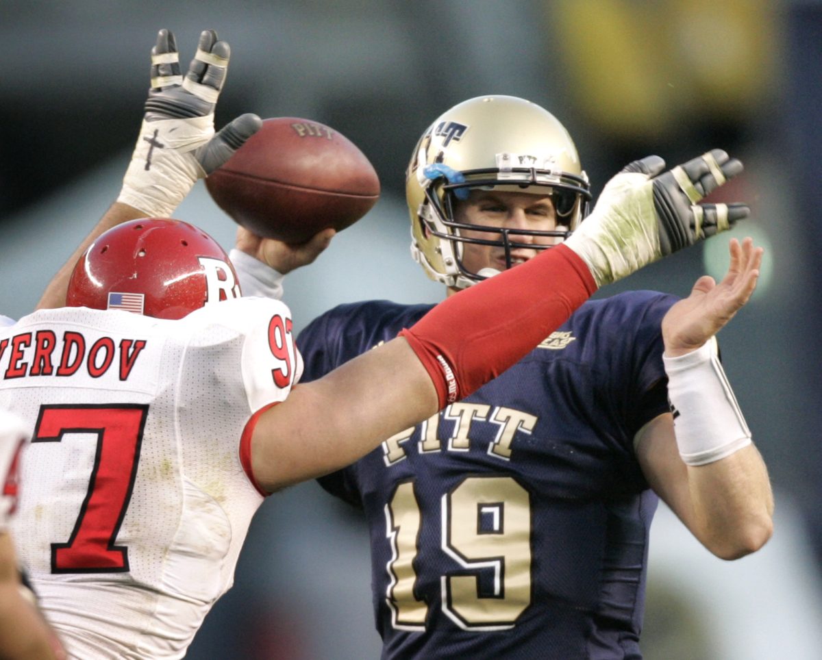 Rutgers defensive tackle Pete Tverdov, left, pressures Pittsburgh backup quarterback Pat Bostick in the second half of an NCAA college football game in Pittsburgh, Saturday, Oct. 25, 2008. Bostick threw an interception on the play as Rutgers defeated Pittsburgh 54-34. (AP Photo/Keith Srakocic)