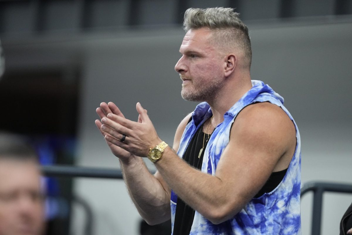 Sports analyst Pat McAfee watches an NFL football game between the Indianapolis Colts and the Houston Texans, Saturday, Jan. 6, 2024, in Indianapolis.