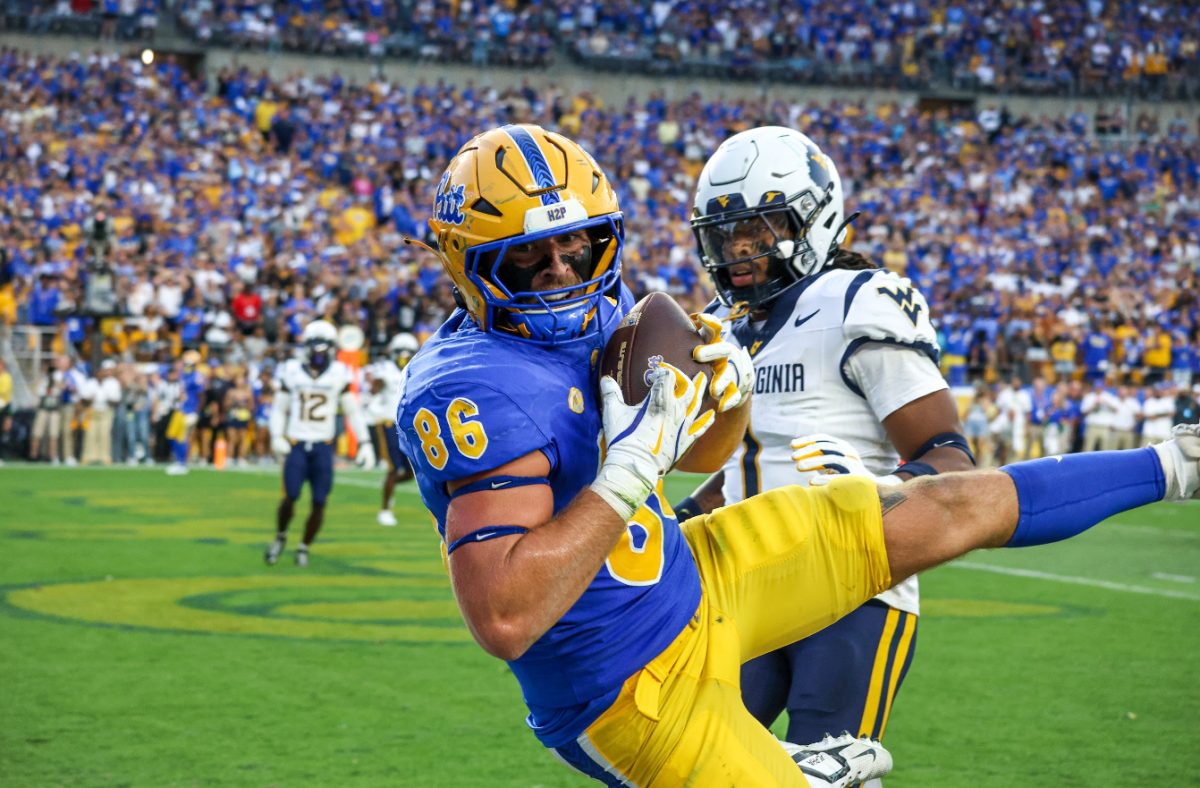 Senior tight end Gavin Bartholomew (86) attempts to score a touchdown at the Backyard Brawl against West Virginia in Acrisure Stadium on Saturday.