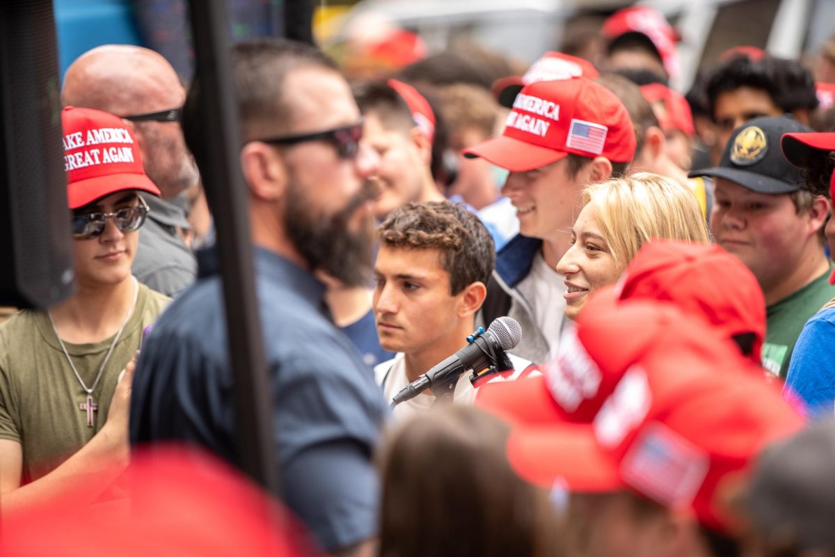 A student asks Charlie Kirk and former Republican Presidential Candidate Vivek Ramaswamy a question during TPUSA’s “You’re Being Brainwashed” tour event in the Schenley Quadrangle on Wednesday.