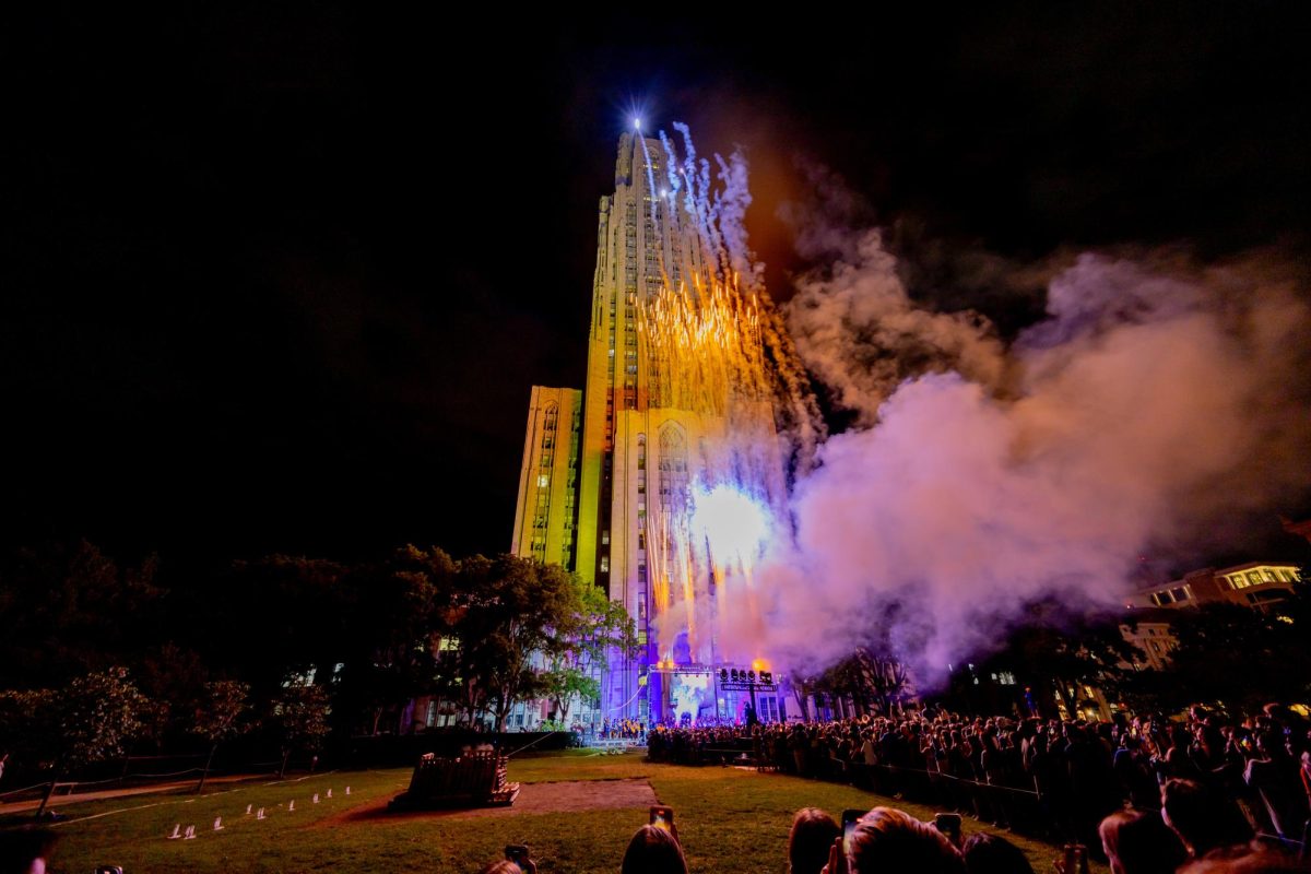 Fireworks go off in front of the Cathedral of Learning as the bonfire is lit at the bonfire and pep rally on Thursday night.