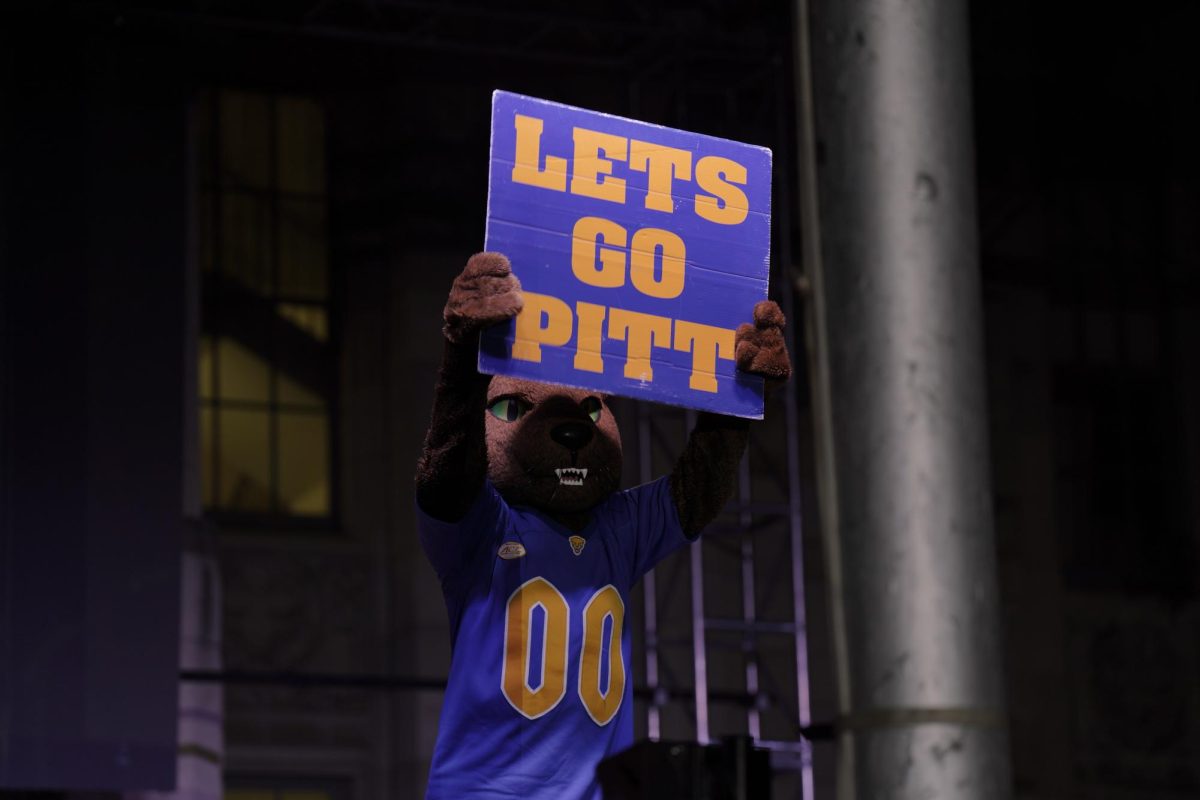 Roc the Panther holds up a sign reading “LETS GO PITT” at the bonfire and pep rally on Aug 29.