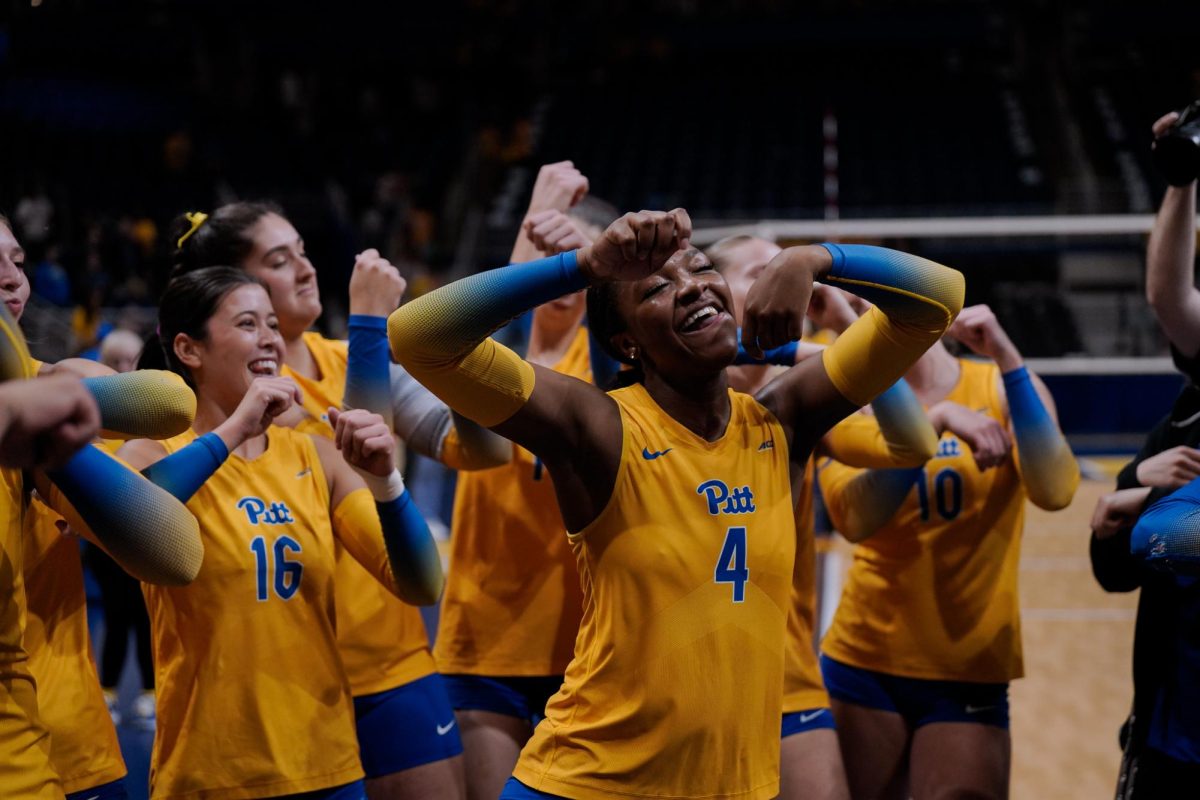 Sophomore outside hitter Torrey Stafford dances with her teammates after following their sweep of Penn State at the Petersen Events Center.