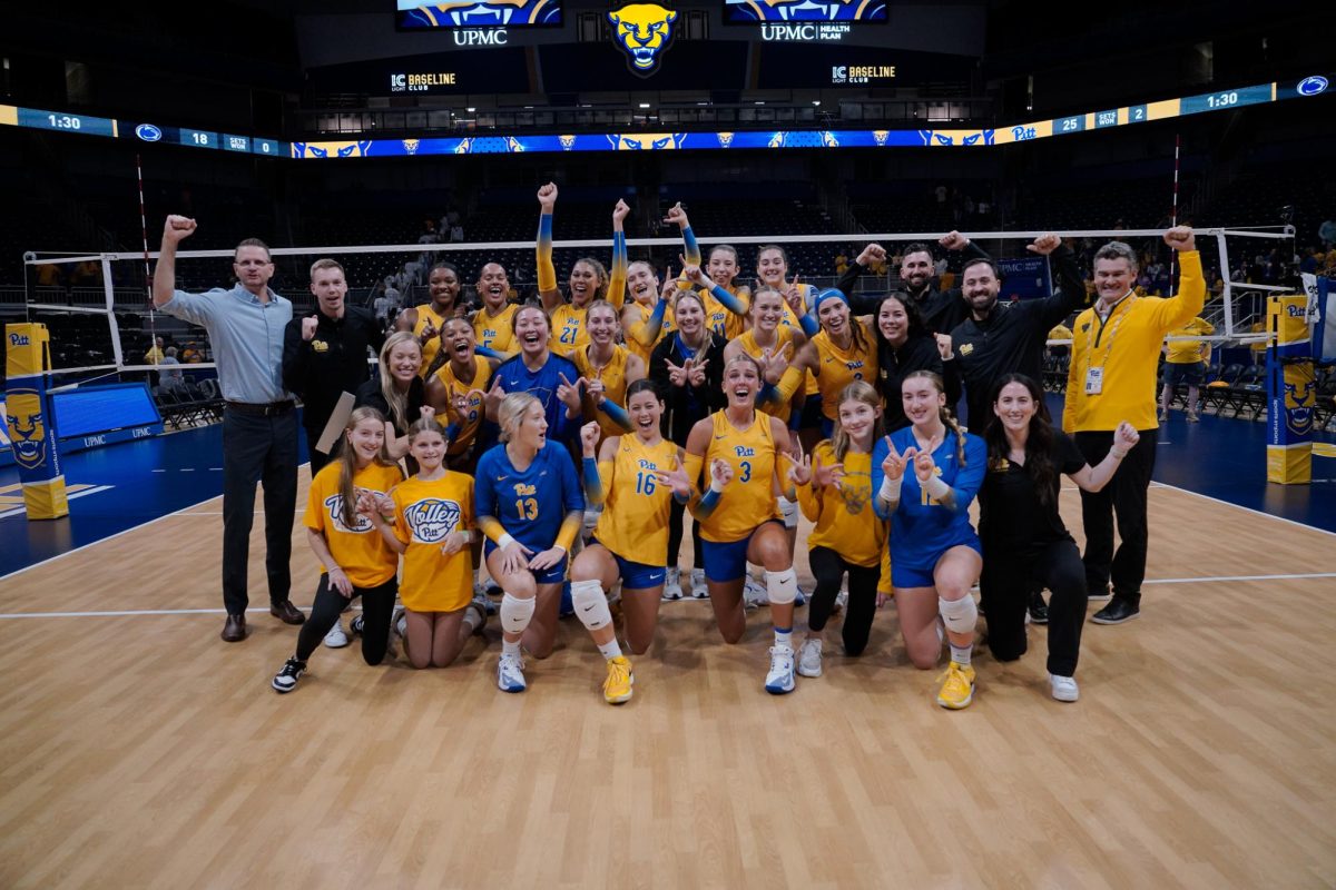 The Pitt volleyball team poses for a photo following its sweep of Penn State at the Petersen Events Center.