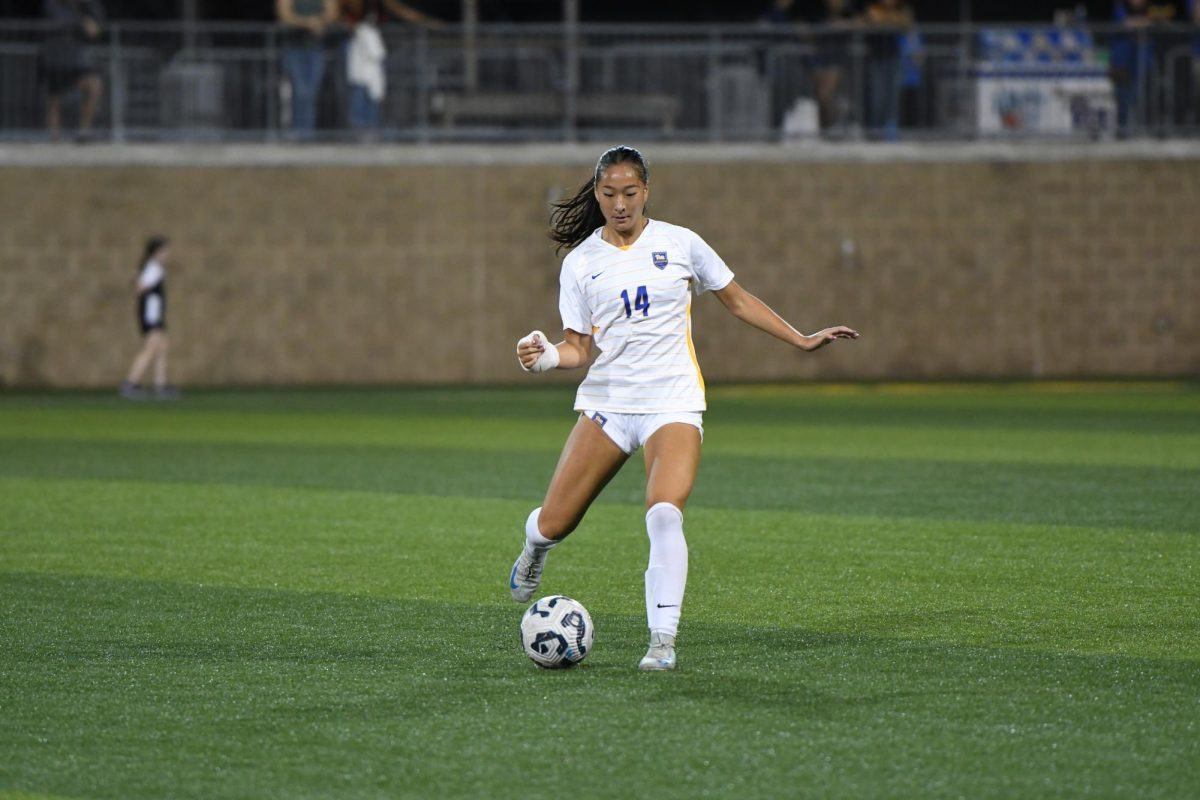 Sophomore defender Olivia Lee prepares to kick the ball during Pitt women’s soccer’s game against Louisville on Saturday at Ambrose Urbanic Field.