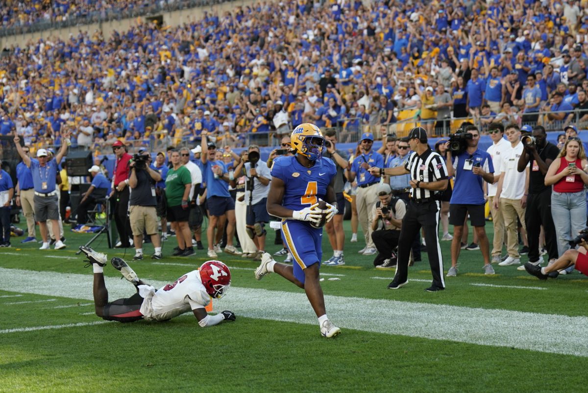 Sixth year running back Daniel Carter (4) scores a touchdown at the football game against Youngstown State at Acrisure Stadium on Saturday.