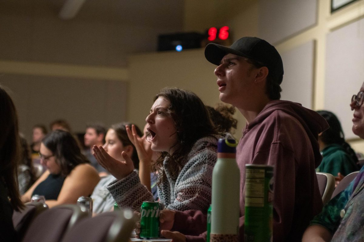 Students watch the debate between Vice President Kamala Harris and former President Donald Trump during the College Democrats debate watch party on Tuesday. 