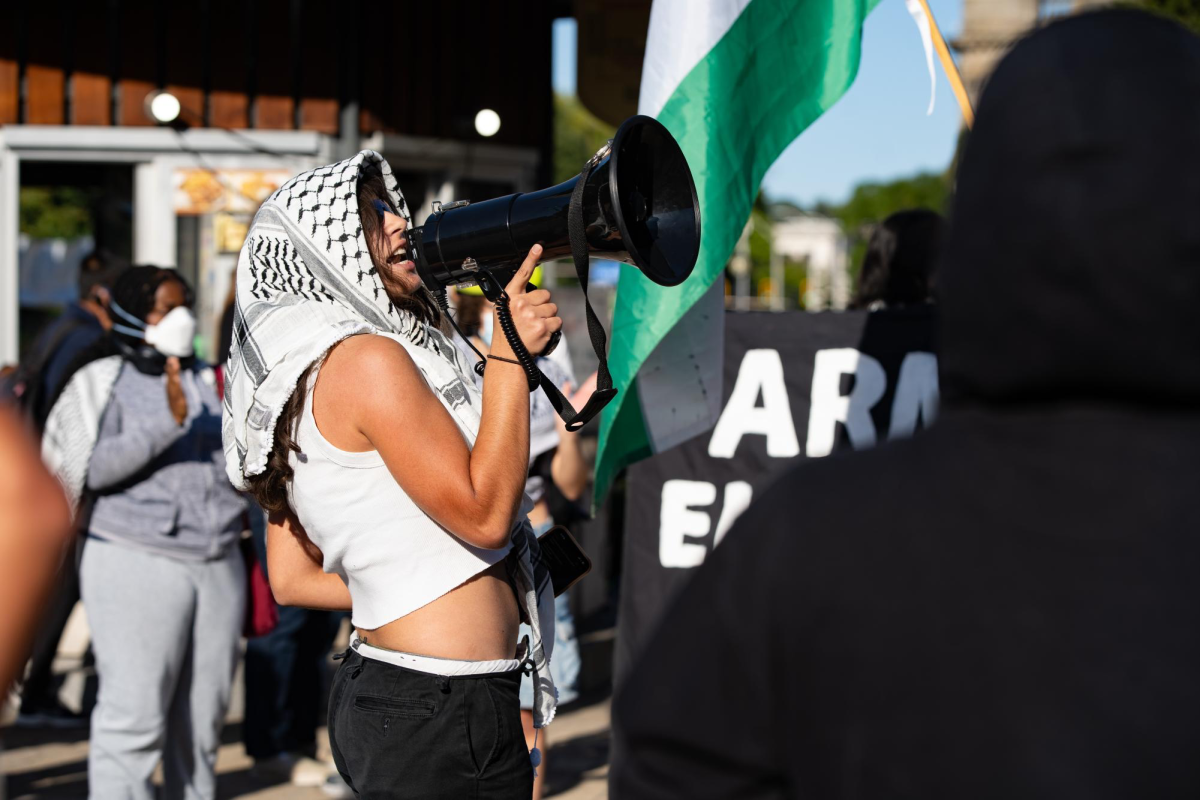 An activist leads the crowd of protesters in chants during the event at Schenley Plaza on Tuesday.