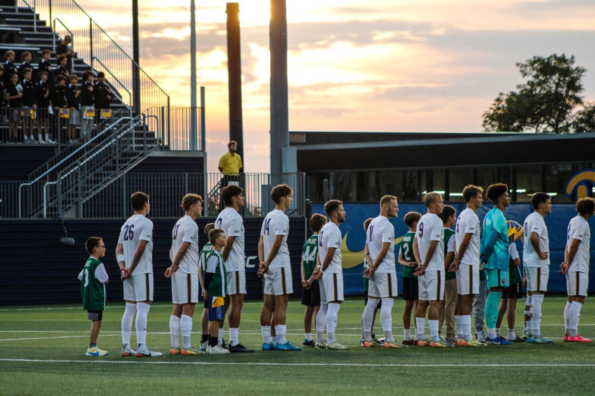 Pitt men’s soccer observes the national anthem at the match against Boston College at Ambrose Urbanic Field on Friday.