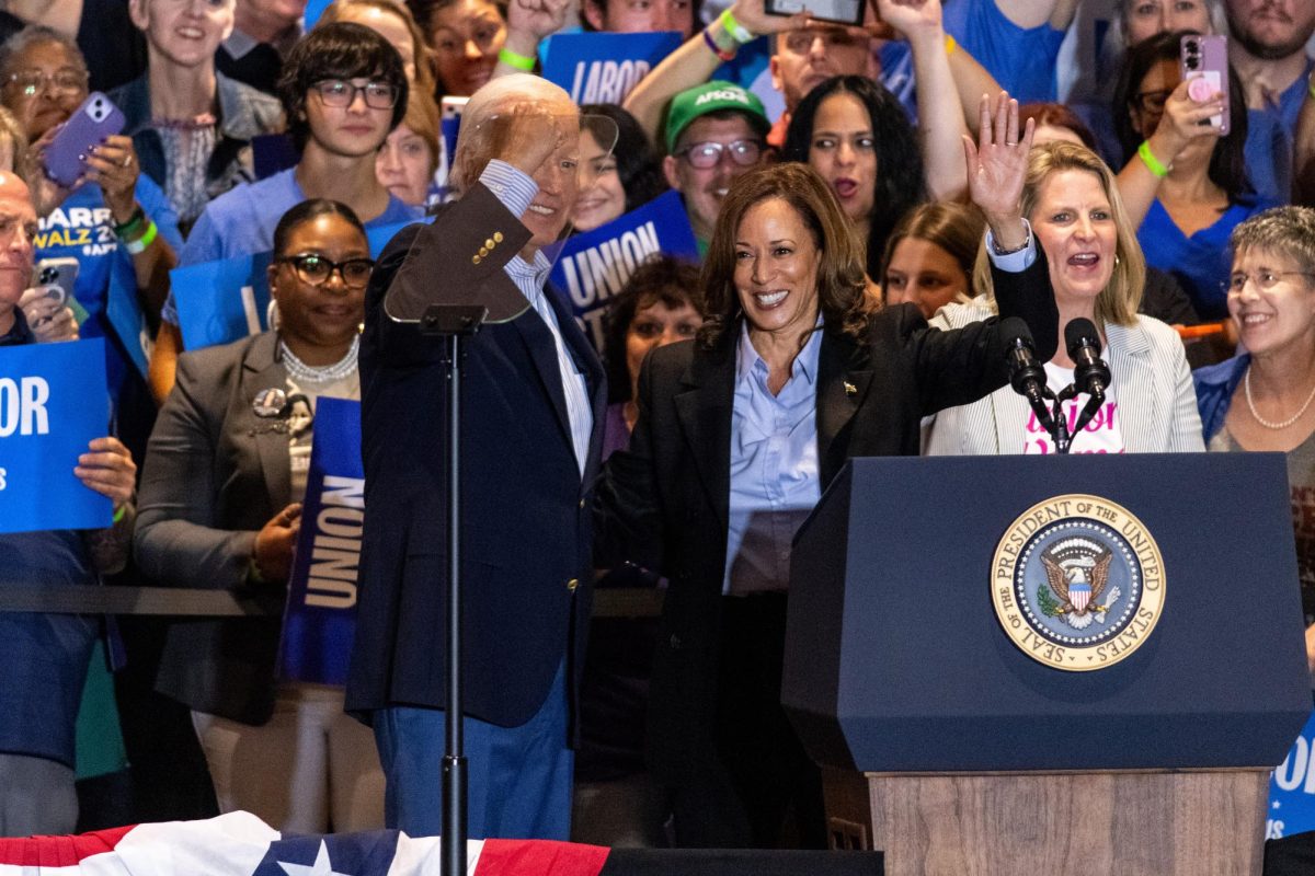 President Joe Biden and Vice President Kamala Harris embrace following Harris's speech at the IBEW Local Union 5 on Monday.