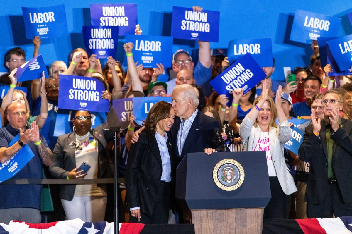 President Joe Biden kisses Vice President Kamala Harris on the forehead prior to her speech during the rally at IBEW Local Union 5 on Monday.