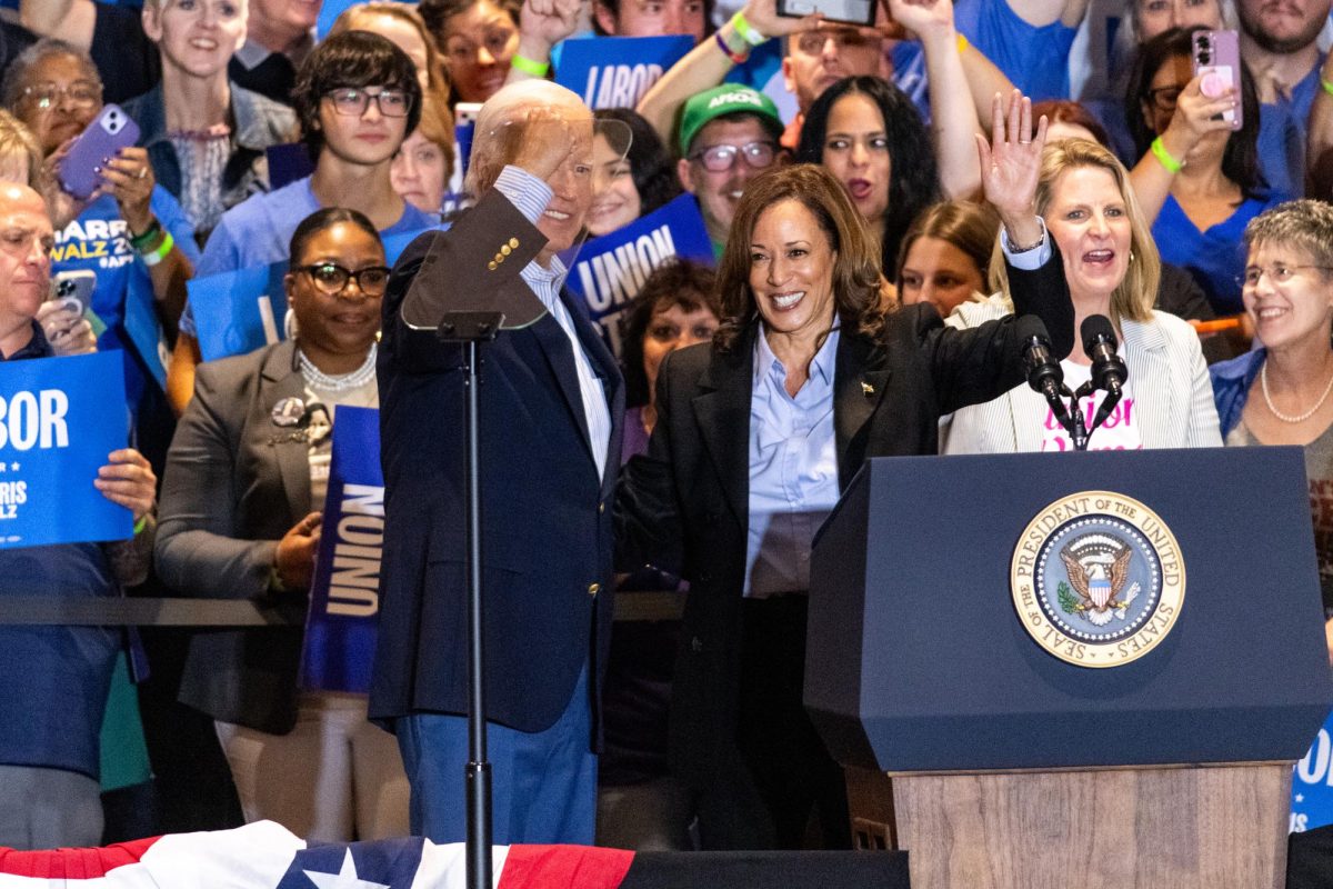 President Joe Biden and Vice President Kamala Harris embrace following Harris' speech at the IBEW Local Union 5 on Monday.