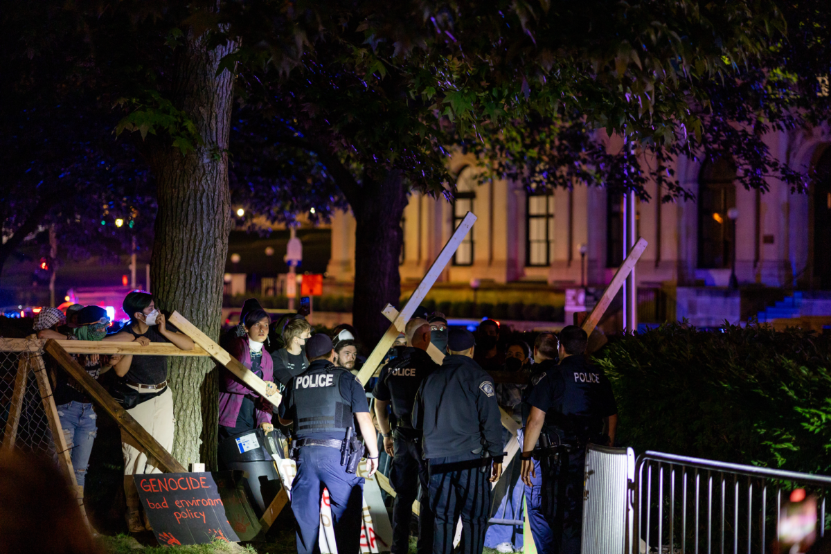 Protesters face police officers at the Palestine Solidarity Encampment earlier this summer.
